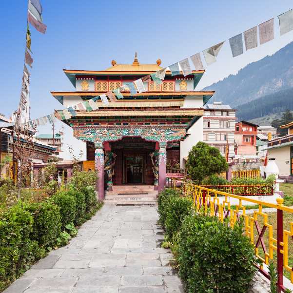A Himalayan Buddhist temple with prayer flags strung across its courtyard.